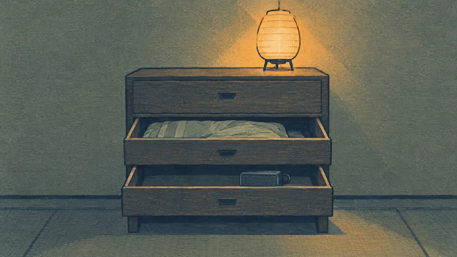 Wooden cabinet with two open drawers under a paper lamp