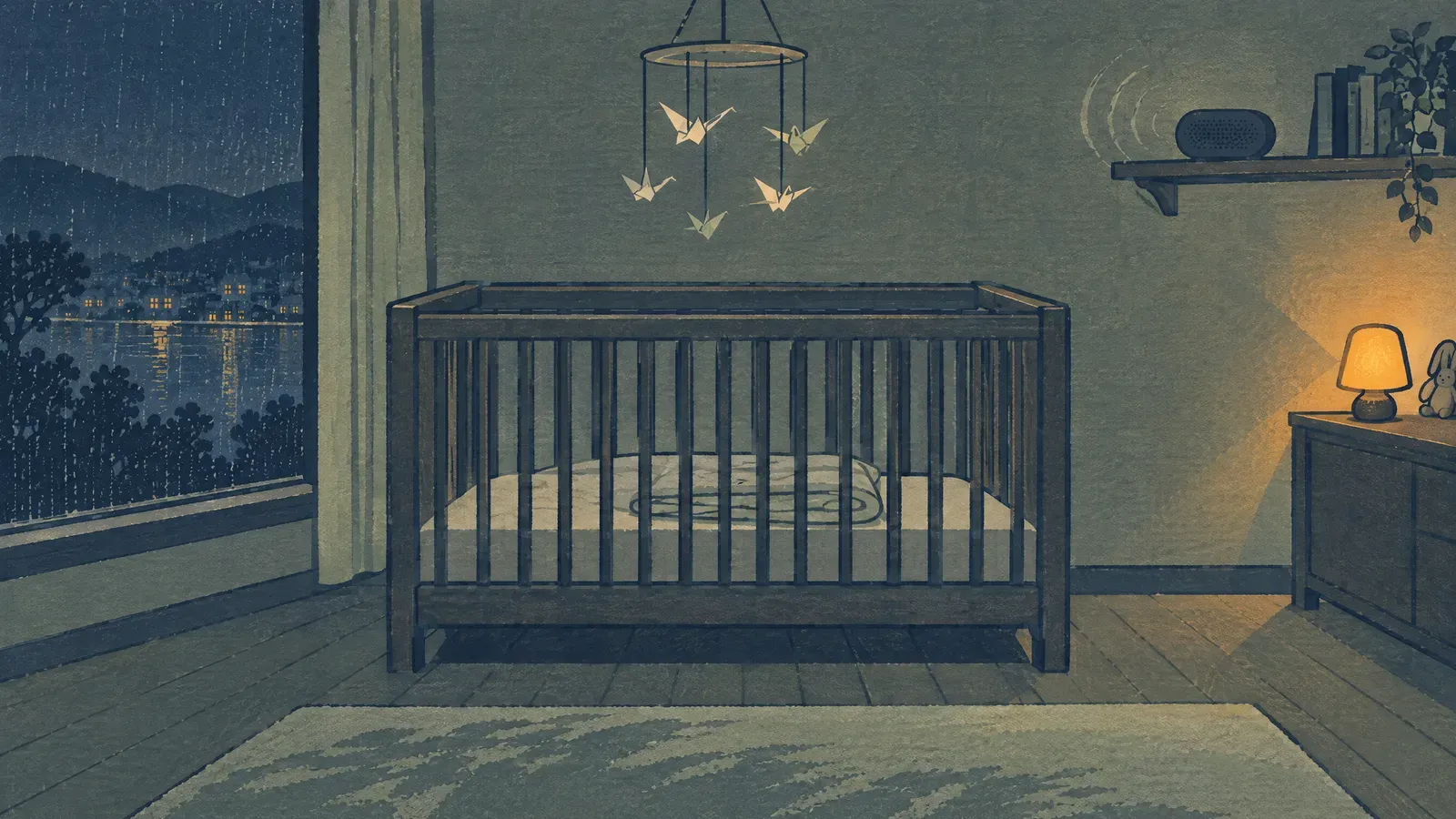 Wooden crib in a nursery at night with a speaker on a far shelf